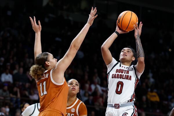 South Carolina guard Te-Hina Paopao (0) shoots against Texas forward Justice Carlton during the first half of an NCAA college basketball game in Columbia, S.C., Sunday, Jan. 12, 2025. (AP Photo/Nell Redmond)