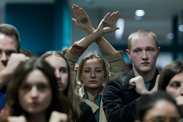 Activists demonstrate in silence protesting a draft of a proposed deal for curbing climate change at the COP29 U.N. Climate Summit, Friday, Nov. 22, 2024, in Baku, Azerbaijan. (AP Photo/Rafiq Maqbool)