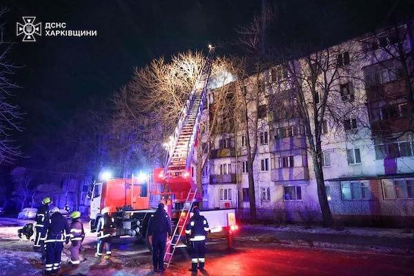 In this photo provided by the Ukrainian Emergency Service, firefighters work on the site of a damaged building after a Russian drone attack in Kharkiv, Ukraine, early Friday, Dec. 13, 2024. (Ukrainian Emergency Service via AP Photo)