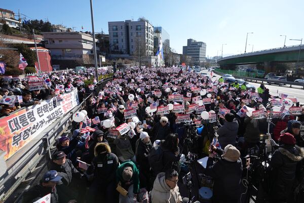 Supporters of impeached South Korean President Yoon Suk Yeol stage a rally near the presidential residence in Seoul, South Korea, Tuesday, Dec. 31, 2024. The letters read "Oppose Impeachment," and "Arrest Lee Jae-myung." (AP Photo/Lee Jin-man)