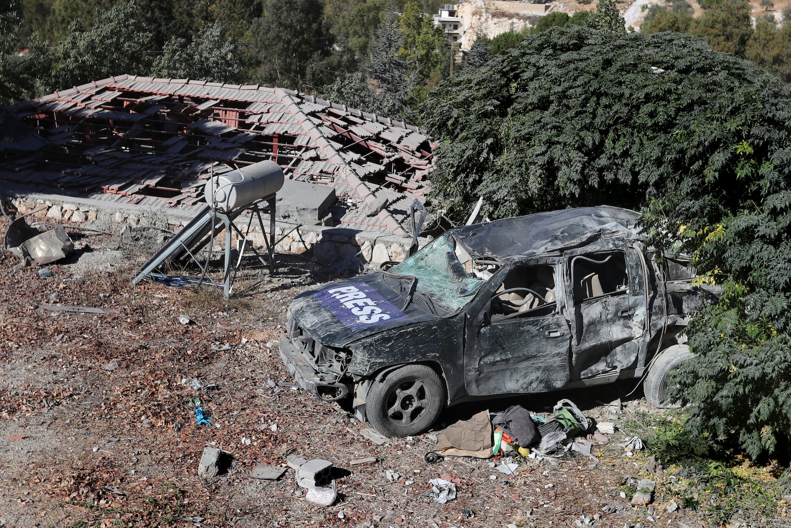 A destroyed journalists' car at the site where an Israeli airstrike hit a compound housing journalists, killing three media staffers from two different news agencies according to Lebanon's state-run National News Agency, in Hasbaya village, southeast Lebanon, Friday, Oct. 25, 2024. (AP Photo/Mohammed Zaatari)