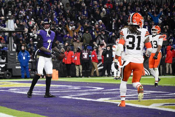 Baltimore Ravens wide receiver Rashod Bateman (7) celebrates after catching a 7-yard touchdown pass Cleveland Browns' Mike Ford Jr. (31) and Mohamoud Diabate, right, stand by during the second half of an NFL football game Saturday, Jan. 4, 2025, in Baltimore. (AP Photo/Nick Wass)