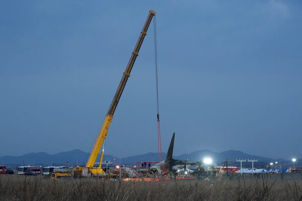 Rescue team members work at the site of a plane fire at Muan International Airport in Muan, South Korea, Sunday, Dec. 29, 2024. (AP Photo/Ahn Young-joon)