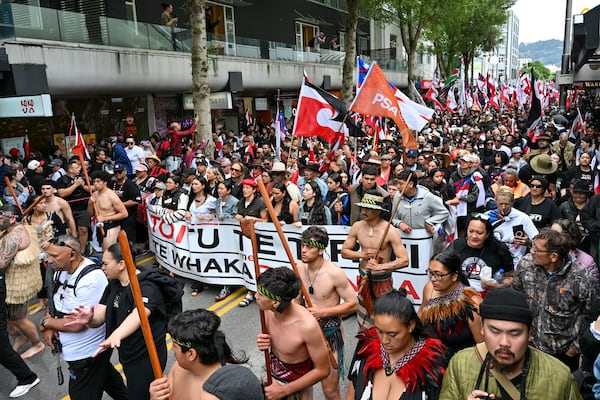 Indigenous Māori march through the central business district to Parliament in Wellington, New Zealand, Tuesday, Nov. 19, 2024. (AP Photo/Mark Tantrum)