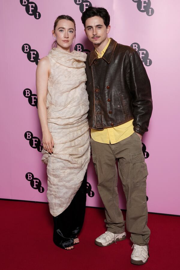 Saoirse Ronan, left, and Timothee Chalamet pose for photographers upon arrival at the photo call for an 'In Conversation' event at the BFI Southbank, on Wednesday, Dec. 18, 2024, in London. (Photo by Scott A Garfitt/Invision/AP)