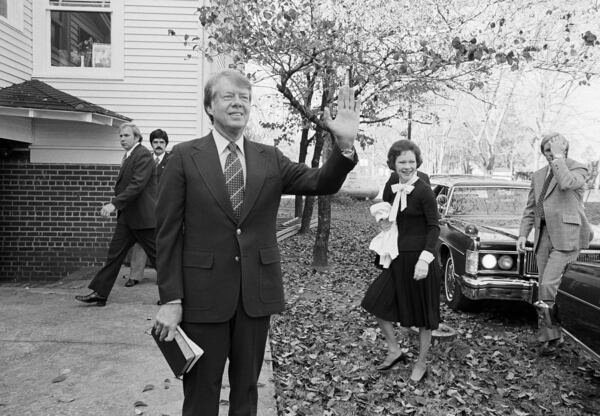 FILE - President-elect Jimmy Carter waves to the crowd as he and his wife Rosalynn arrive at the Plains Baptist Church to attend services in Plains, Ga., Nov. 22, 1976. (AP Photo, File)