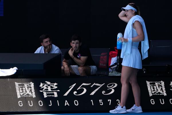 Paula Badosa of Spain talks with her coaches during her quarterfinal match against Coco Gauff of the U.S. during their quarterfinal match at the Australian Open tennis championship in Melbourne, Australia, Tuesday, Jan. 21, 2025. (AP Photo/Manish Swarup)