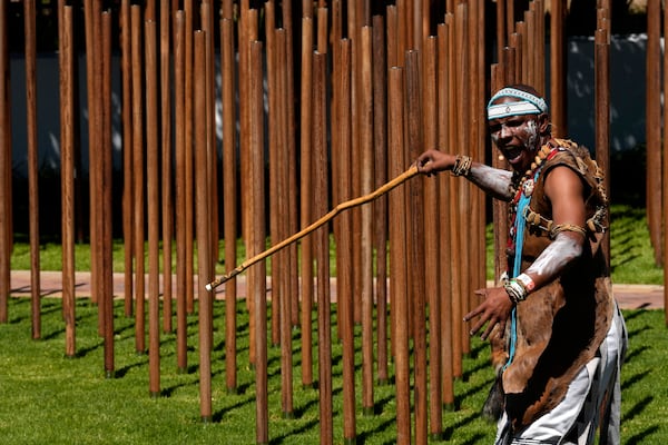 A praise poet performs a cultural tribute at the opening of a memorial dedicated to more than 1,700 Black South African servicemen who died in non-combatant roles in World War I and have no known grave, in Cape Town, South Africa, Wednesday, Jan. 22, 2025. (AP Photo/Nardus Engelbrecht)