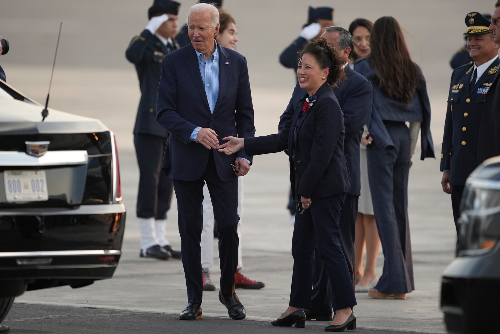 U.S. President Joe Biden, left, shakes hands with US Ambassador to Peru Stephanie Syptak-Ramnath on the airport tarmac ahead of the Asia-Pacific Economic Cooperation (APEC) summit, in Lima, Peru, Thursday, Nov. 14, 2024. (AP Photo/Guadalupe Pardo)