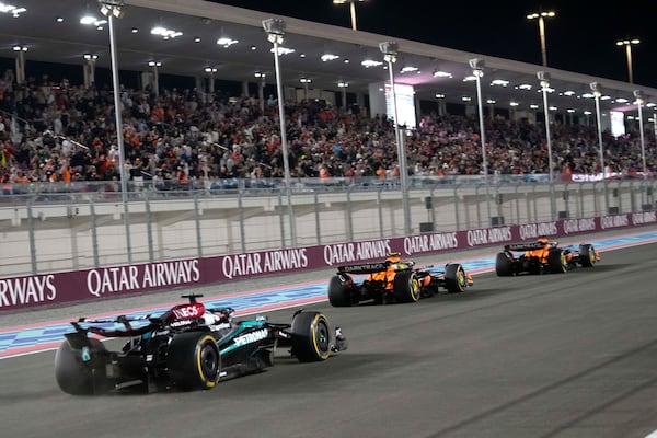 McLaren driver Oscar Piastri of Australia is crosses the finish line followed by his teammate McLaren driver Lando Norris of Britain and Mercedes driver George Russell of Britain during sprint race at the Formula One Qatar Grand Prix, at the Lusail International Circuit in Lusail, Qatar, Saturday, Nov. 30, 2024. (AP Photo/Pool/ Altaf Qadri)