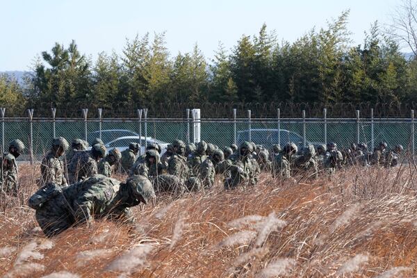 South Korean army soldiers work outside of Muan International Airport in Muan, South Korea, Tuesday, Dec. 31, 2024, following Sunday's plane crash. (AP Photo/Ahn Young-joon)