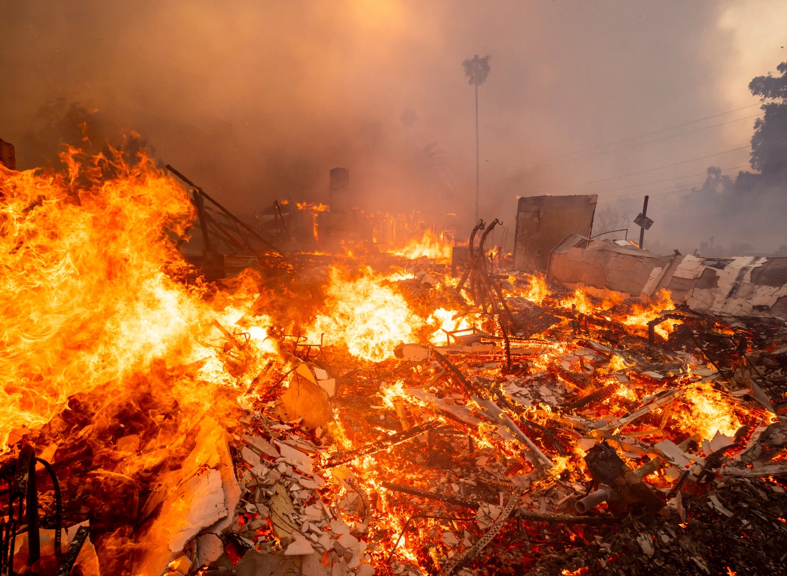 Flames engulf a structure during the Mountain Fire, Wednesday, Nov. 6, 2024, near Camarillo, Calif. (AP Photo/Ethan Swope)