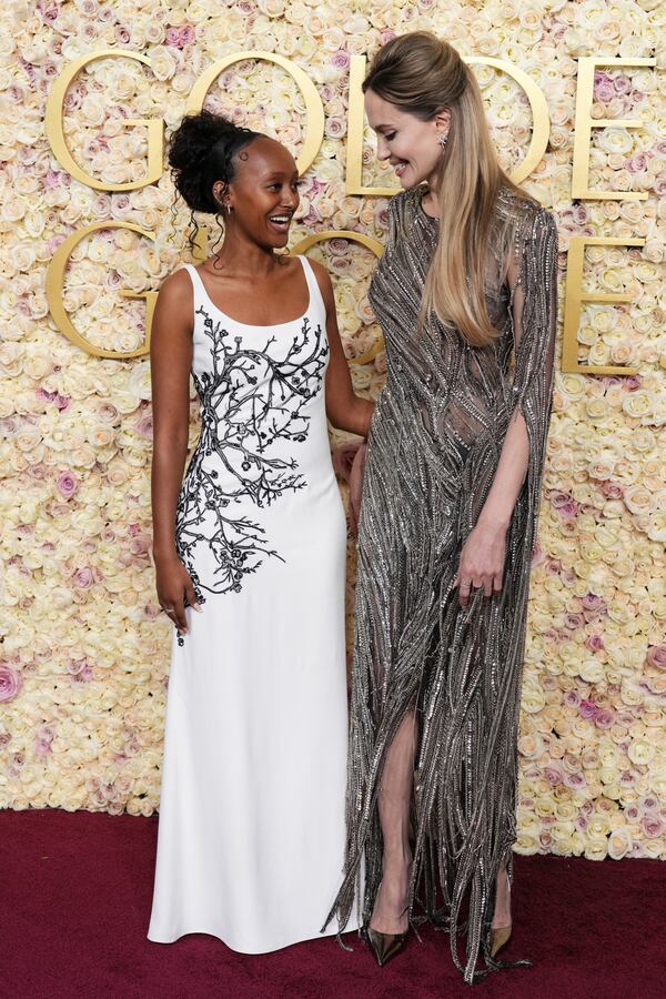 Zahara Jolie, left, and Angelina Jolie arrive at the 82nd Golden Globes on Sunday, Jan. 5, 2025, at the Beverly Hilton in Beverly Hills, Calif. (Photo by Jordan Strauss/Invision/AP)