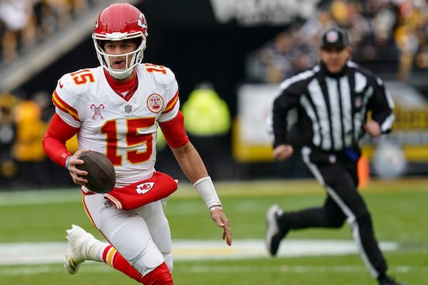 Kansas City Chiefs quarterback Patrick Mahomes (15) runs out of the backfield against the Pittsburgh Steelers during the first half of an NFL football game, Wednesday, Dec. 25, 2024, in Pittsburgh. (AP Photo/Matt Freed)