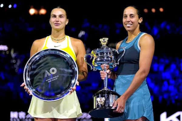 Madison Keys, right, of the U.S. holds the Daphne Akhurst Memorial Cup after defeating Aryna Sabalenka, left, of Belarus in the women's singles final at the Australian Open tennis championship in Melbourne, Australia, Saturday, Jan. 25, 2025. (AP Photo/Asanka Brendon Ratnayake)