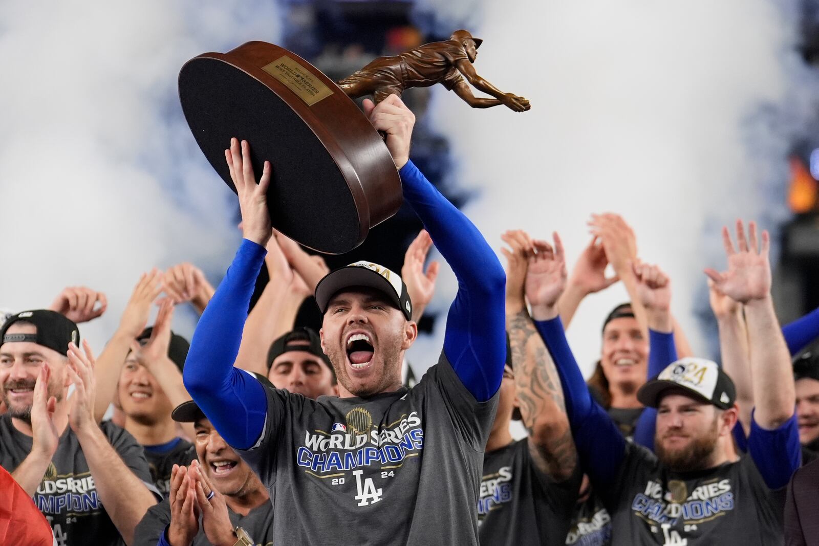 Los Angeles Dodgers' Freddie Freeman celebrates with the MVP trophy after their win against the New York Yankees in Game 5 to win the baseball World Series, Thursday, Oct. 31, 2024, in New York. (AP Photo/Ashley Landis)