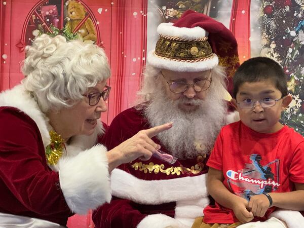 Santa and Mrs. Claus talk to a child in Yakutat, Alaska, in the Alaska National Guard's Operation Santa program, Wednesday, Dec. 18, 2024. (AP Photo/Mark Thiessen)