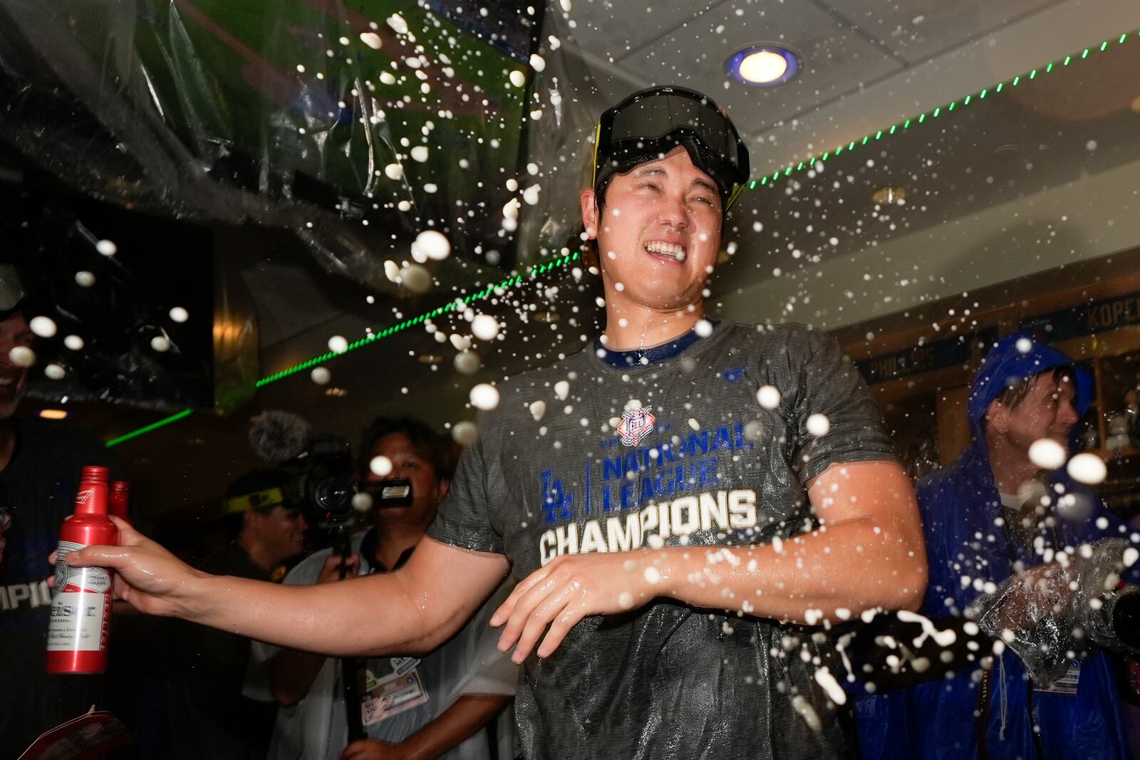 Los Angeles Dodgers Yoshinobu Yamamoto celebrates in the locker room after their win against the New York Mets in Game 6 of a baseball NL Championship Series, Sunday, Oct. 20, 2024, in Los Angeles. The Dodgers will face the New York Yankees in the World Series. (AP Photo/Ashley Landis)