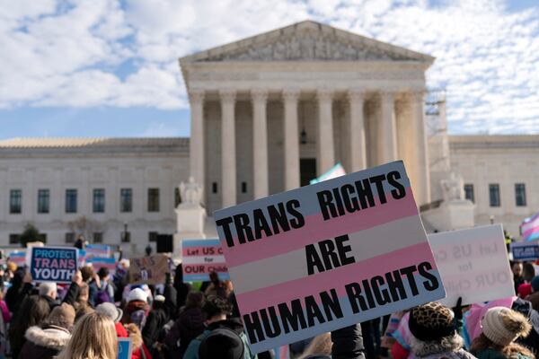 FILE - Transgenders rights supporters rally outside of the Supreme Court, Wednesday, Dec. 4, 2024, in Washington. (AP Photo/Jose Luis Magana, File)