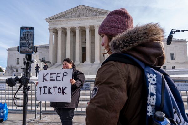 Callie Goodwin, of Columbia, S.C., holds a sign in support of TikTok outside the Supreme Court, Friday, Jan. 10, 2025, in Washington. Goodwin, a small business owner who sells personalized greeting cards, says 80% of her sales come from people who found her on TikTok. (AP Photo/Jacquelyn Martin)