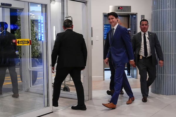 Canadian Prime Minister Justin Trudeau walks through the lobby of the Delta Hotel by Marriott, Friday, Nov. 29, 2024, in West Palm Beach, Fla. (AP Photo/Carolyn Kaster)