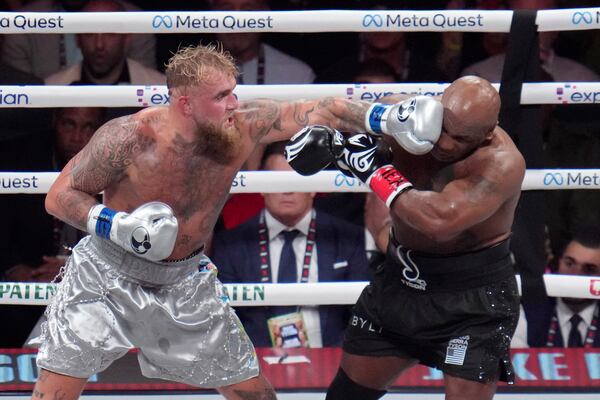 FILE - Jake Paul lands a left to Mike Tyson during their heavyweight boxing match, Nov. 15, 2024, in Arlington, Texas. (AP Photo/Julio Cortez, File)