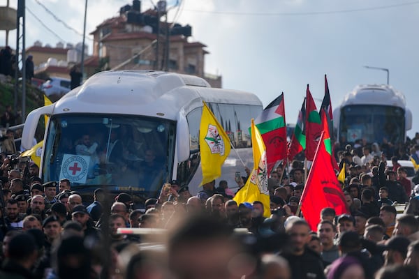 Buses carrying Palestinian prisoners are greeted by a crowd after being released from Israeli prison following a ceasefire agreement with Israel, in the West Bank city of Ramallah, Saturday, Jan. 25, 2025. (AP Photo/Nasser Nasser)