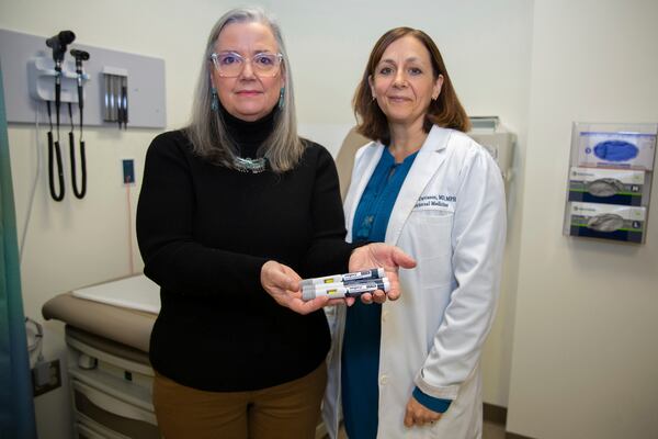 Patient Lory Osborn (left) holds Wegovy pens used in her treatment with Dr. Laura Davisson, director of the Medical Weight Management at West Virginia University in Morgantown, W.Va., Monday, Dec. 2, 2024. (AP Photo/Kathleen Batten)