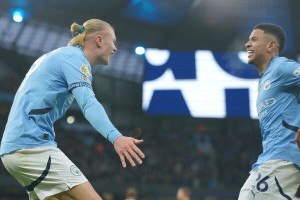 Manchester City's Erling Haaland, left, is congratulated by Savinho after scoring his side's 2nd goal against West Ham during a English Premier League soccer match at Etihad stadium in Manchester, England, Saturday, Jan. 4, 2025. (AP Photo/Ian Hodgson)