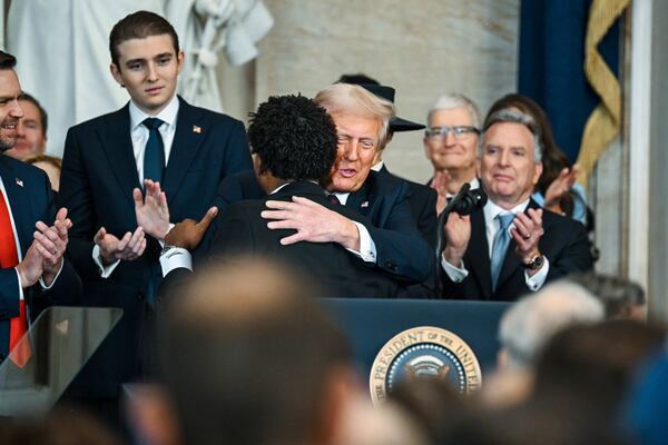 Senior Pastor Lorenzo Sewell, second left, hugs President Donald Trump during the 60th Presidential Inauguration in the Rotunda of the U.S. Capitol in Washington, Monday, Jan. 20, 2025. (Kenny Holston/The New York Times via AP, Pool)