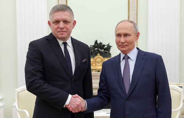 Russian President Vladimir Putin, right, and Slovak Prime Minister Robert Fico shake hands during their meeting at the Kremlin in Moscow, Russia, Sunday, Dec. 22, 2024. (Gavriil Grigorov, Sputnik, Kremlin Pool Photo via AP)