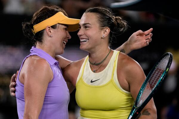 Aryna Sabalenka, right, of Belarus, is congratulated by Anastasia Pavlyuchenkova of Russia following their quarterfinal match at the Australian Open tennis championship in Melbourne, Australia, Tuesday, Jan. 21, 2025. (AP Photo/Ng Han Guan)