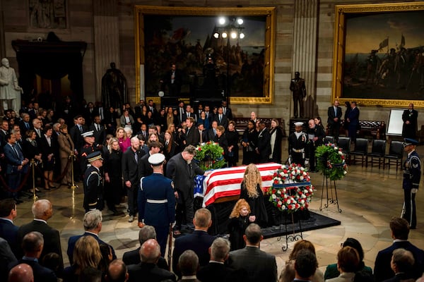 The Carter family pay their respects during a ceremony as the flag-draped casket of former President Jimmy Carter lies in state, at the Capitol, Tuesday, Jan. 7, 2025, in Washington. Carter died Dec. 29 at the age of 100. (Kent Nishimura/The New York Times via AP, Pool)