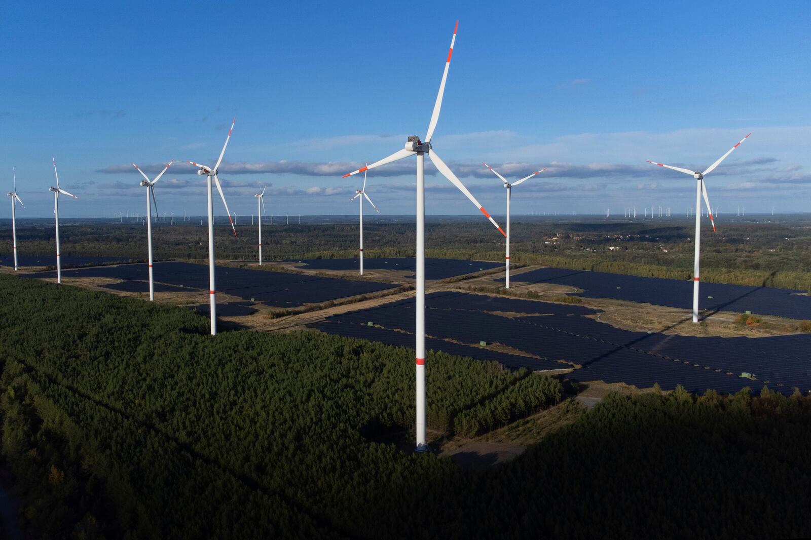 Wind turbines operate at the Klettwitz Nord solar energy park near Klettwitz, Germany, Tuesday, Oct. 15, 2024. (AP Photo/Matthias Schrader)