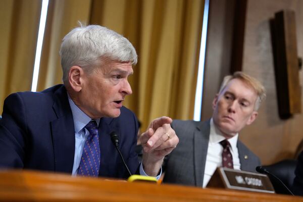 Sen. Bill Cassidy, R-La., left, speaks as Sen. James Lankford, R-Okla., right, listens at the Senate Finance Committee confirmation hearing for Scott Bessent, President-elect Donald Trump's choice to be Secretary of the Treasury, at the Capitol in Washington, Thursday, Jan. 16, 2025. (AP Photo/Ben Curtis)