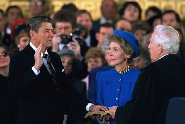 FILE - First lady Nancy Reagan, center, looks on as President Ronald Reagan is sworn in during ceremonies in the Rotunda beneath the Capitol Dome in Washington, Jan. 21, 1985. (AP Photo/Ron Edmonds, File)