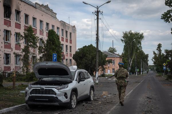 FILE - A Ukrainian soldier walks past a building in Sudzha, Kursk region, Russia, on Aug. 16, 2024. This image was approved by the Ukrainian Defense Ministry before publication. (AP Photo, File)