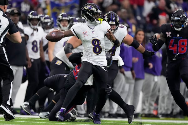 Baltimore Ravens quarterback Lamar Jackson (8) throws a pass during the first half of an NFL football game against the Houston Texans, Wednesday, Dec. 25, 2024, in Houston. (AP Photo/Eric Christian Smith)