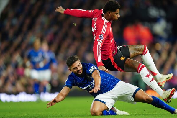 Ipswich Town's Sam Morsy, bottom, tackles Manchester United's Marcus Rashford during the English Premier League soccer match between Ipswich Town and Manchester United at Portman Road stadium in Ipswich, England, Sunday, Nov. 24, 2024. (AP Photo/Dave Shopland)