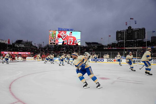 The Chicago Blackhawks and St. Louis Blues warm up before the NHL Winter Classic outdoor hockey game at Wrigley Field, Tuesday, Dec. 31, 2024, in Chicago. (AP Photo/Erin Hooley)