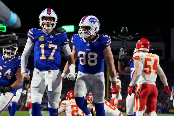 Buffalo Bills quarterback Josh Allen (17) is congratulated by teammate Dawson Knox (88) after scoring on a 26-yard run during the second half of an NFL football game against the Kansas City Chiefs Sunday, Nov. 17, 2024, in Orchard Park, N.Y. (AP Photo/Julia Demaree Nikhinson)