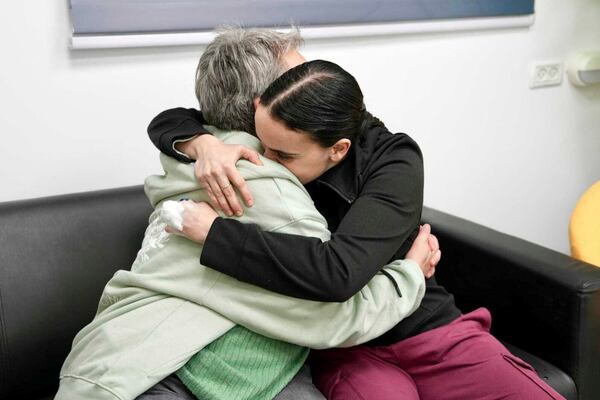 In this photo released by the Israeli Army, Emily Damari, right, and her mother Mandy use a smart phone near kibbutz Reim, southern Israel after Emily was released from captivity by Hamas militants in Gaza, Sunday, Jan. 19, 2025. (Israeli Army via AP)