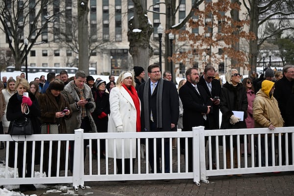 People watch West Virginia Governor Patrick Morrisey speak following his swearing in at the state capitol in Charleston, W.Va., on Monday, Jan. 13, 2025. (AP Photo/Chris Jackson)