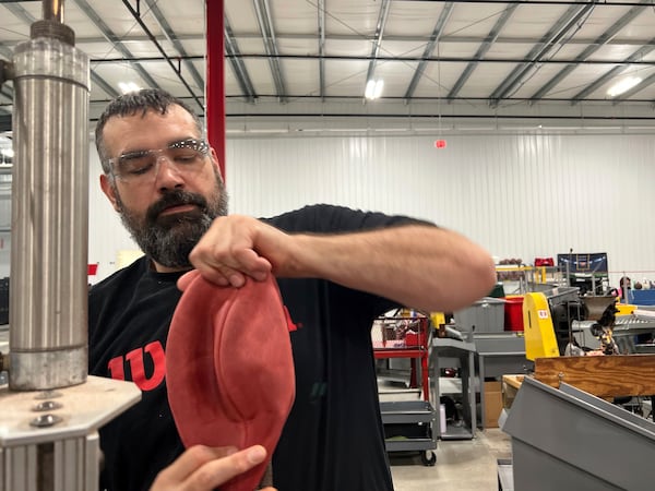 Wilson Sporting Goods football factory employee Derek Gibson operates a machine that turns the football for the upcoming Super Bowl matchup between the Philadelphia Eagles and the Kansas City Chiefs from inside-out, Monday, January 27, 2025, in Ada, Ohio. (AP Photo/Patrick Aftoora-Orsagos)