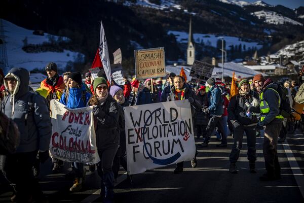 Protestors attend a two-day hike from Kueblis to Davos as part of a demonstration of the collective 'Strike WEF' in Switzerland, Saturday, Jan. 18, 2025 ahead of the annual meeting of the World Economic Forum, WEF, in Davos. (Michael Buholzer/Keystone via AP)