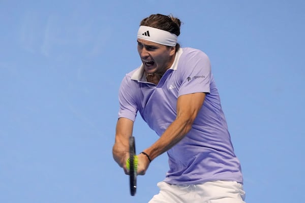 Germany's Alexander Zverev returns the ball to Spain's Carlos Alcaraz during their singles tennis match of the ATP World Tour Finals at the Inalpi Arena, in Turin, Italy, Friday, Nov. 15, 2024. (AP Photo/Antonio Calanni)