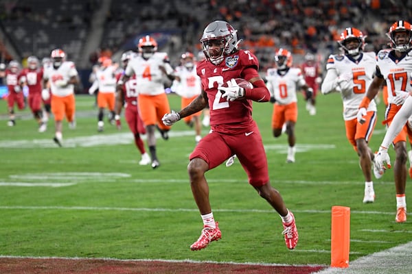 Washington State wide receiver Kyle Williams (2) breaks away from Syracuse defenders as he scores on a touchdown reception during the first half of the Holiday Bowl NCAA college football game Friday, Dec. 27, 2024, in San Diego. (AP Photo/Denis Poroy)