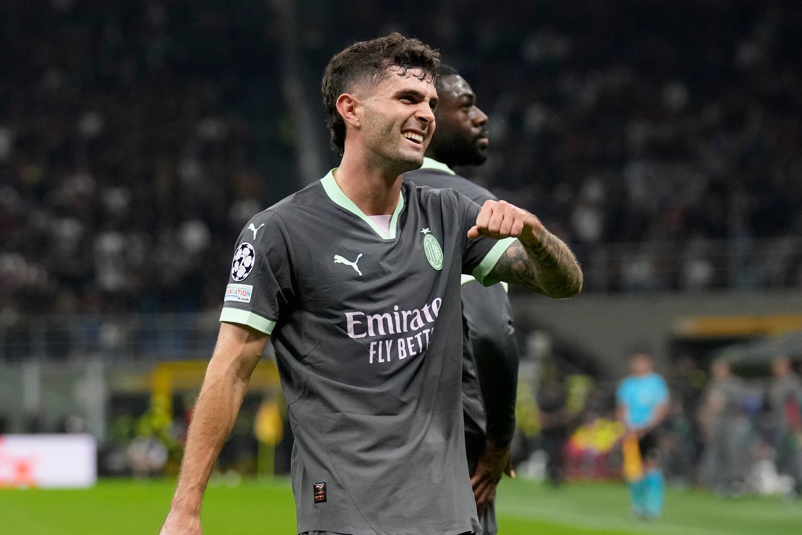 AC Milan's Christian Pulisic reacts after scoring the opening goal of his team during the Champions League opening phase soccer match between AC Milan and Club Brugge at the San Siro stadium in Milan, Italy, Tuesday, Oct. 22, 2024. (AP Photo/Antonio Calani)