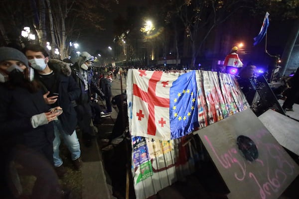 Demonstrators build a barricade during a rally outside the parliament's building to protest the government's decision to suspend negotiations on joining the European Union for four years in Tbilisi, Georgia, early Sunday, Dec. 1, 2024. (AP Photo/Zurab Tsertsvadze)