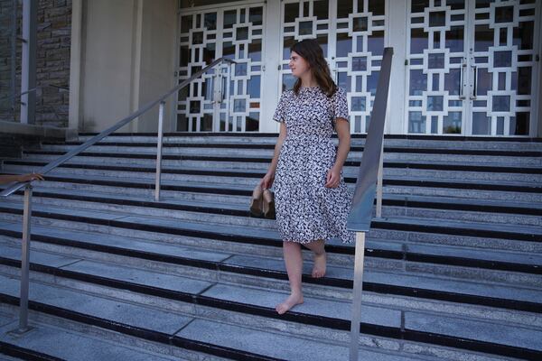 Zoey Stapleton carries her shoes while leaving morning Mass at her home parish, St. Joan of Arc Catholic Church in Hershey, Pa., Wednesday, July 3, 2024. (AP Photo/Jessie Wardarski)